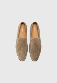 Brown suede loafers with a smooth texture, rounded toe, leather insole, and minimal stitching detail. No visible hardware or embellishments.