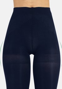 Granatowe legginsy z wysokim stanem, z teksturowanymi paskami wokół ud i gładkim wykończeniem materiału.