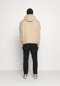 Karl Kani UNISEX SMALL SIGNATURE HOODY  - Sweatshirt com capuz - sand