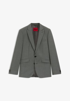 Harmaa bleiseri, joka on valmistettu teksturoidusta kankaasta. Siinä on lovinen kaulus, kaksi etutaskua, mustat napit ja punainen sisämerkki.