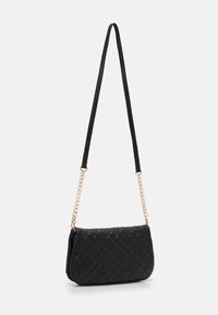Svart kviltad handväska med rektangulär form, slät textur och kedjeackcenter. Försedd med en lång, justerbar rem.