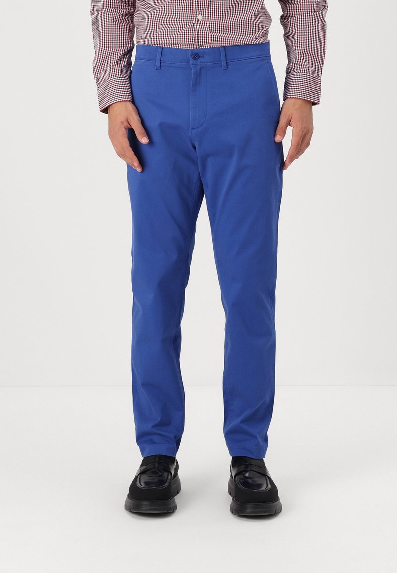 Bright blue trousers made of smooth fabric, featuring a slim fit design with a flat front, side pockets, and a belt loop waistband.