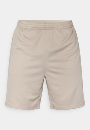 Beežid hingavast kangast sportluspüksid, millel on elastne vöökoht ja sile tekstuur. Omavad lahtist lõiget ja õmblustega aktsente.