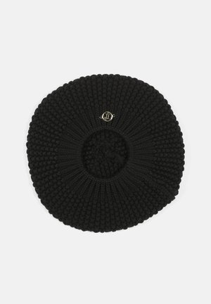 Black knitted beret with a textured surface, circular shape, and a small gold-tone logo detail at the center.