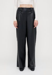 Black faux leather wide-leg pants with a high waist, featuring two front pockets and decorative buttons at the waistband. Smooth texture.