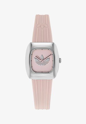 Ruutukujuline käekell hõbedase roostevabast terasest korpuse ja roosa kummirihmaga. Kellal on roosa sihverplaat hõbeda kolme triibuga logoga ning hõbedased osutid.