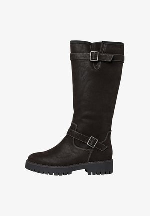 Tall black faux suede boots with a thick rubber sole, featuring a decorative strap and buckle accent near the ankle and a stitched detail.