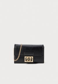 Black leather crossbody bag with a gold chain strap, featuring a rectangular gold and black logo plaque on the front. Smooth texture, sleek design.