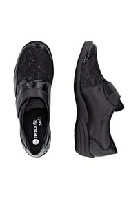 Chaussures noires avec une finition brillante et un motif en peau de serpent. Dotées d'une sangle Velcro et d'une semelle rembourrée pour le confort.