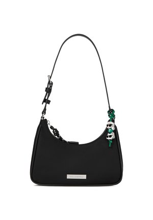 Black shoulder bag with adjustable strap, silver brand plaque, and small green and white cartoon character charms on side.
