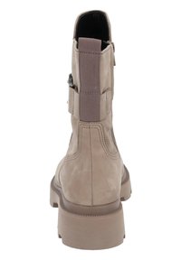 Beige suede ankle boots with a rugged sole, elastic side panel, and zip detail. Flat heel and smooth texture. Back view.