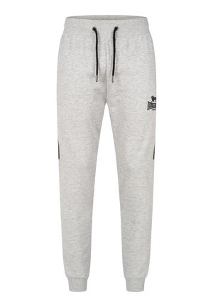Light grey sweatpants made of soft fabric, featuring an elastic waistband with black drawstrings and side pockets, with a logo on the thigh.