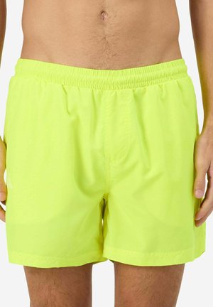 Costume da bagno giallo neon realizzati in un materiale leggero, con una vita elastica e una texture liscia, dal design semplice e senza motivi.