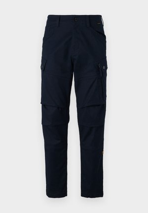 Pantaloni cargo navy realizzati in tessuto resistente, con numerose tasche, una tasca con zip sul lato e dettagli di cucitura in evidenza.