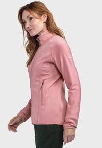 Hellrosa Zip-up-Jacke mit texturiertem Finish, hohem Kragen, langen Ärmeln und einer mit Reißverschluss versehenen Tasche auf der linken Seite.