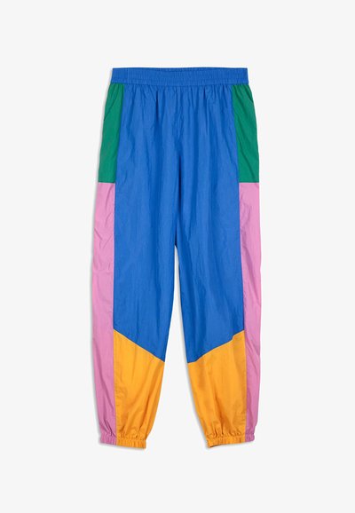 Colorful track pants featuring panels in blue, green, pink, and orange. Made from lightweight fabric with an elastic waistband and cuffs.
