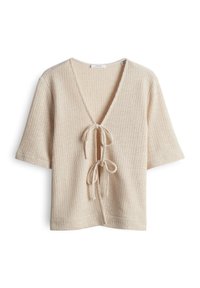 Beige gebreid kort mouw vest met diepe V-hals en twee sluitingen met strik aan de voorkant, geribbelde textuur en een losse pasvorm.