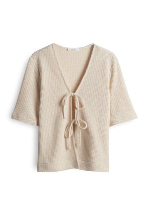 Cardigan beige à manches courtes en tricot, col en V profond et deux liens noués à l'avant, texture côtelée, coupe décontractée.