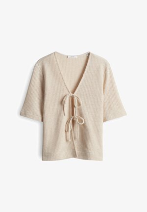 Cardigan beige à manches courtes en tricot, col en V profond et deux liens noués à l'avant, texture côtelée, coupe décontractée.