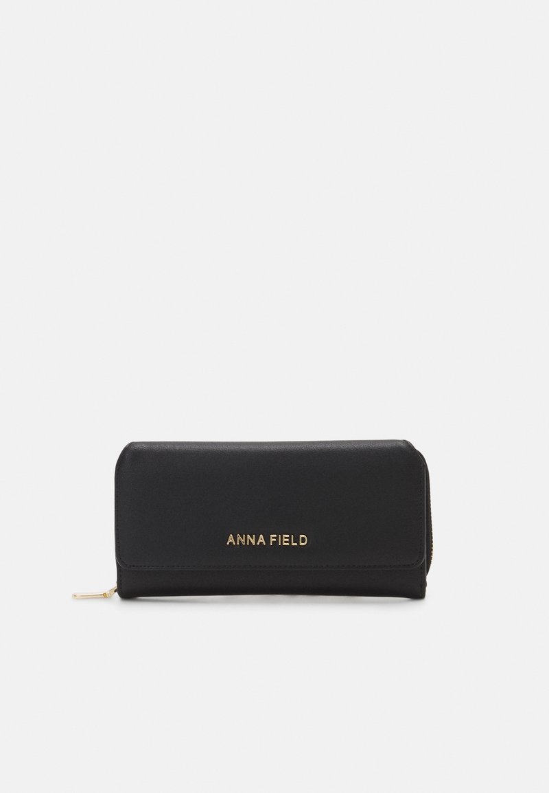 Portefeuille synthétique noir au design épuré, arborant un logo doré et une fermeture éclair. Forme rectangulaire avec une texture lisse.