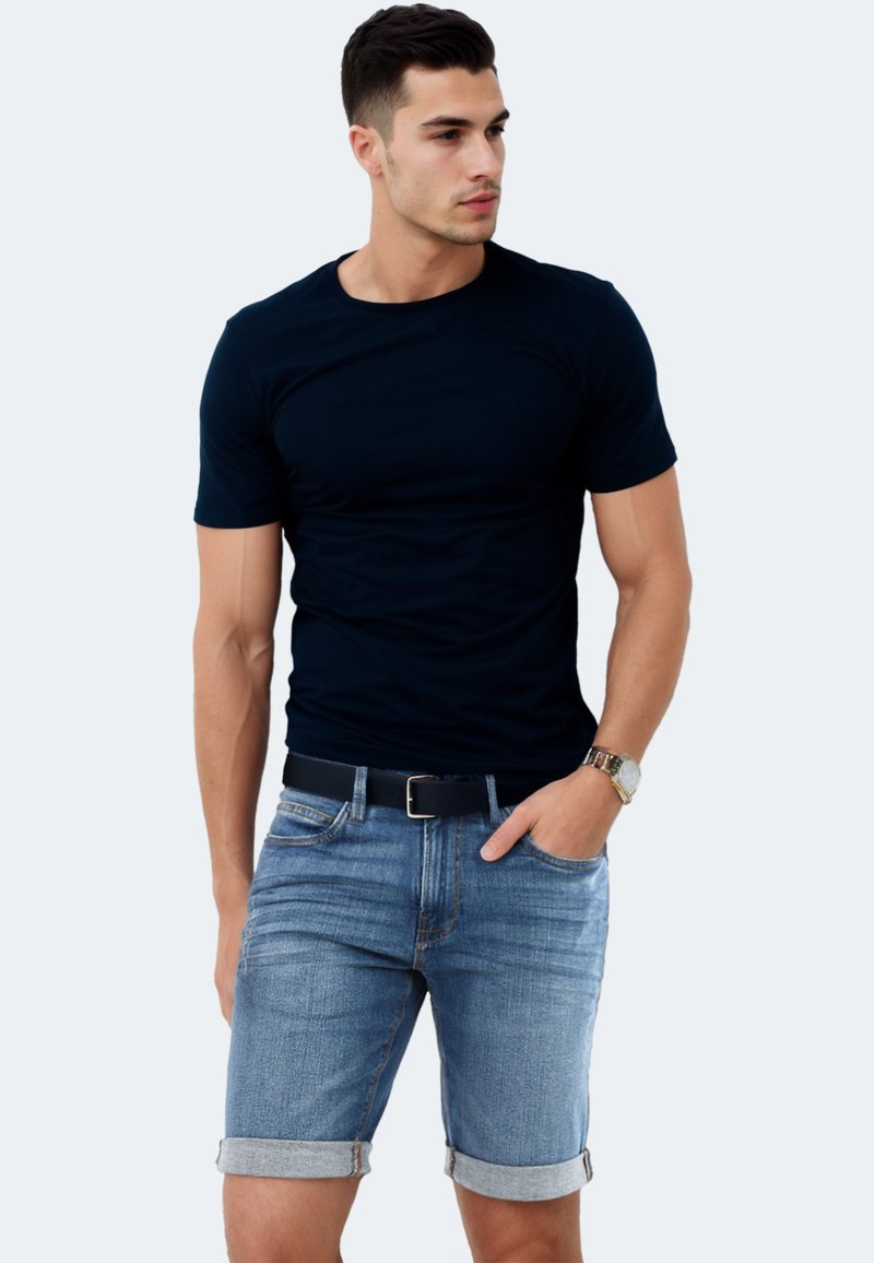 Navy t-shirt with short sleeves paired with light blue denim shorts featuring cuffed hems. Includes a black belt and a silver watch.
