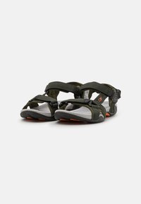 Olive green sandals with adjustable straps, a textured rubber sole, and a cushioned footbed. Notable for orange accents and a secure fit.