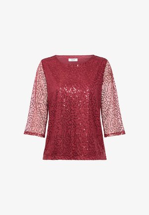 Punane sädelev topp, millel on kolmveerand pikkusega läbipaistvad varrukad, abstraktne muster, ümmargune kaelus ja tekstureeritud kangas.