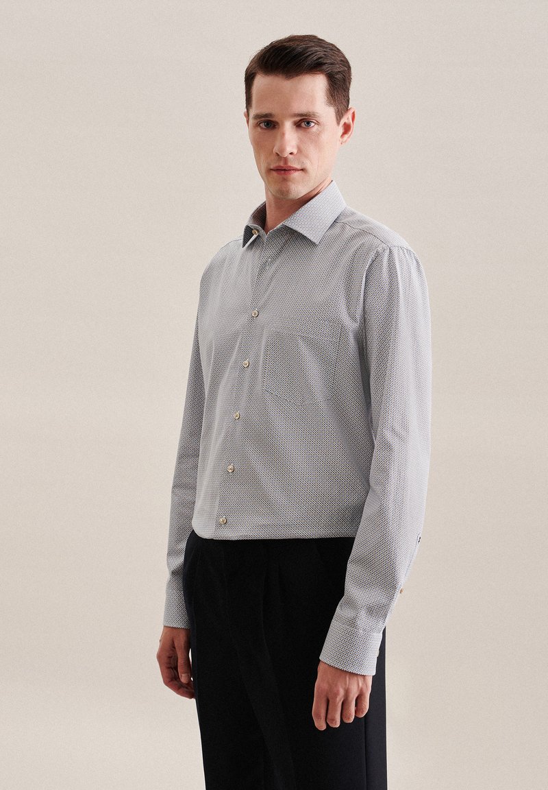 Camicia azzurro chiaro con bottoni, a micro-disegni, maniche lunghe, colletto a punta e taschino, realizzata in tessuto liscio e tessuto.