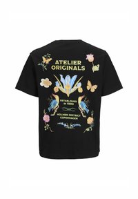 Černé tričko s krátkým rukávem s barevnými květinovými a motýlími grafikami, textem "ATELIER ORIGINALS" a žlutým písmem, doplněné dekorativními prvky.