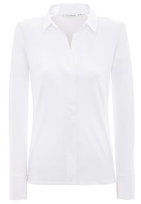 Camicia bianca a maniche lunghe realizzata in tessuto liscio, con colletto classico, chiusura con bottoni e vestibilità su misura. Design pulito, senza fantasie né accenti.
