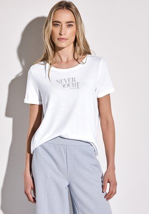 White t-shirt with a round neck and short rolled sleeves; features a printed text design in gray reading "NEVER DOUBT" on the front.