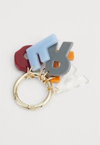 A gold metal keyring holds colorful, shaped resin charms: maroon, blue, gray, orange, and clear letter and geometric designs.