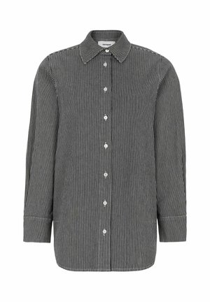 Melna un balta svītraina krekla ar garām piedurknēm, apkakli un baltām pogām. Izgatavota no viegla auduma ar gludu tekstūru.