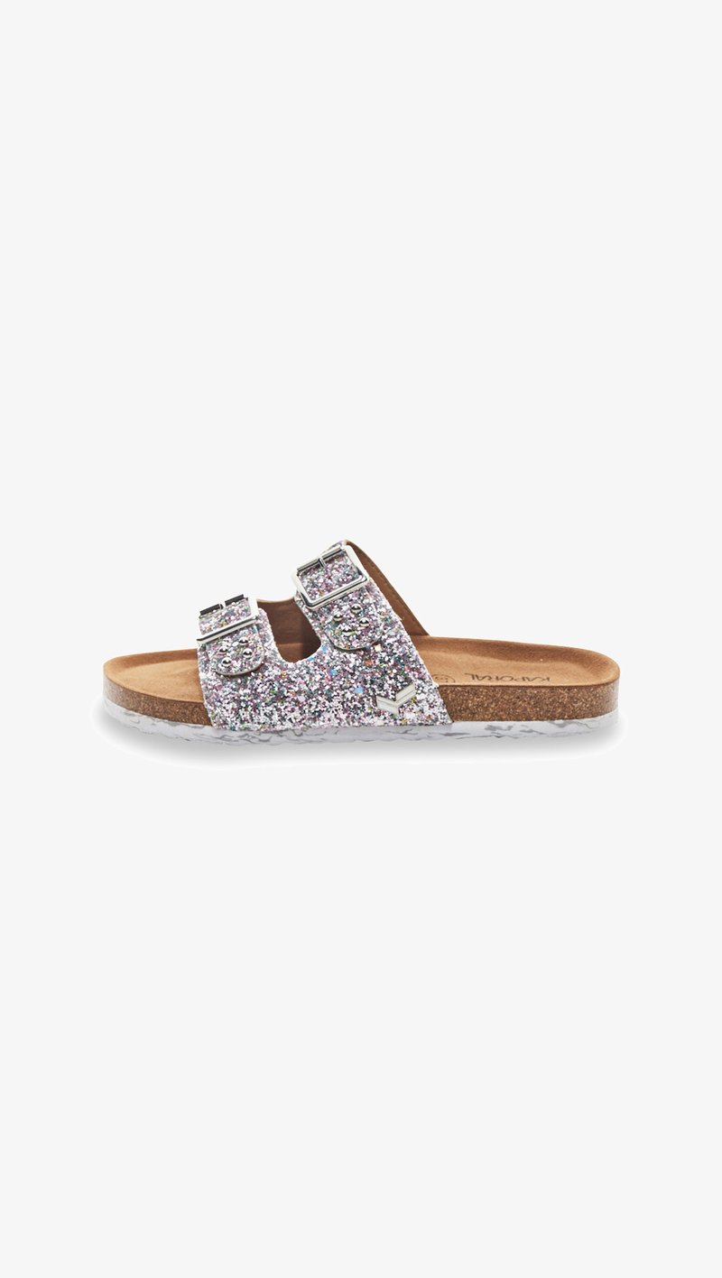 Glittery silver slide sandal with two adjustable buckle straps, contoured cork footbed, and translucent outsole, featuring a flat design.