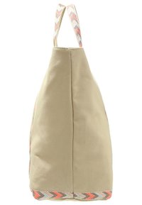 Beige värinen kangaskassi, jossa siksak-kuvioitu koriste. Varustettu tukevalla kahvalla ja ryhdikkäällä muodolla, sopii arkipäiväiseen käyttöön.