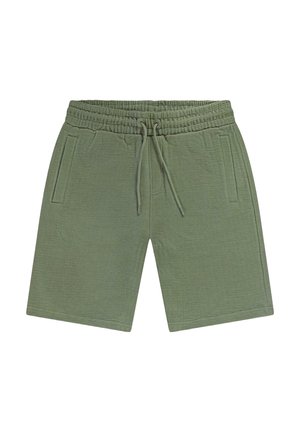 Lichtgroene, getextureerde gebreide korte broek met elastische tailleband, trekkoord en zijzakken met zijsplit, plat neergelegd op een witte achtergrond.