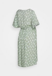 Zielona sukienka z krótkimi rękawami, ozdobiona białym geometrycznym wzorem i paskiem w talii. Miękki materiał o luźnym kroju.