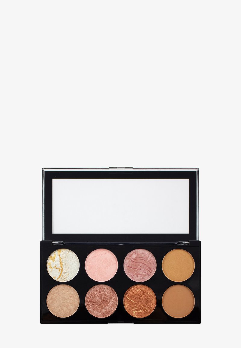 Sminkpalett med åtte runde panner i forskjellige nyanser av beige, fersken, rosa, bronse og gull, i en svart kompakt med gjennomsiktig lokk.