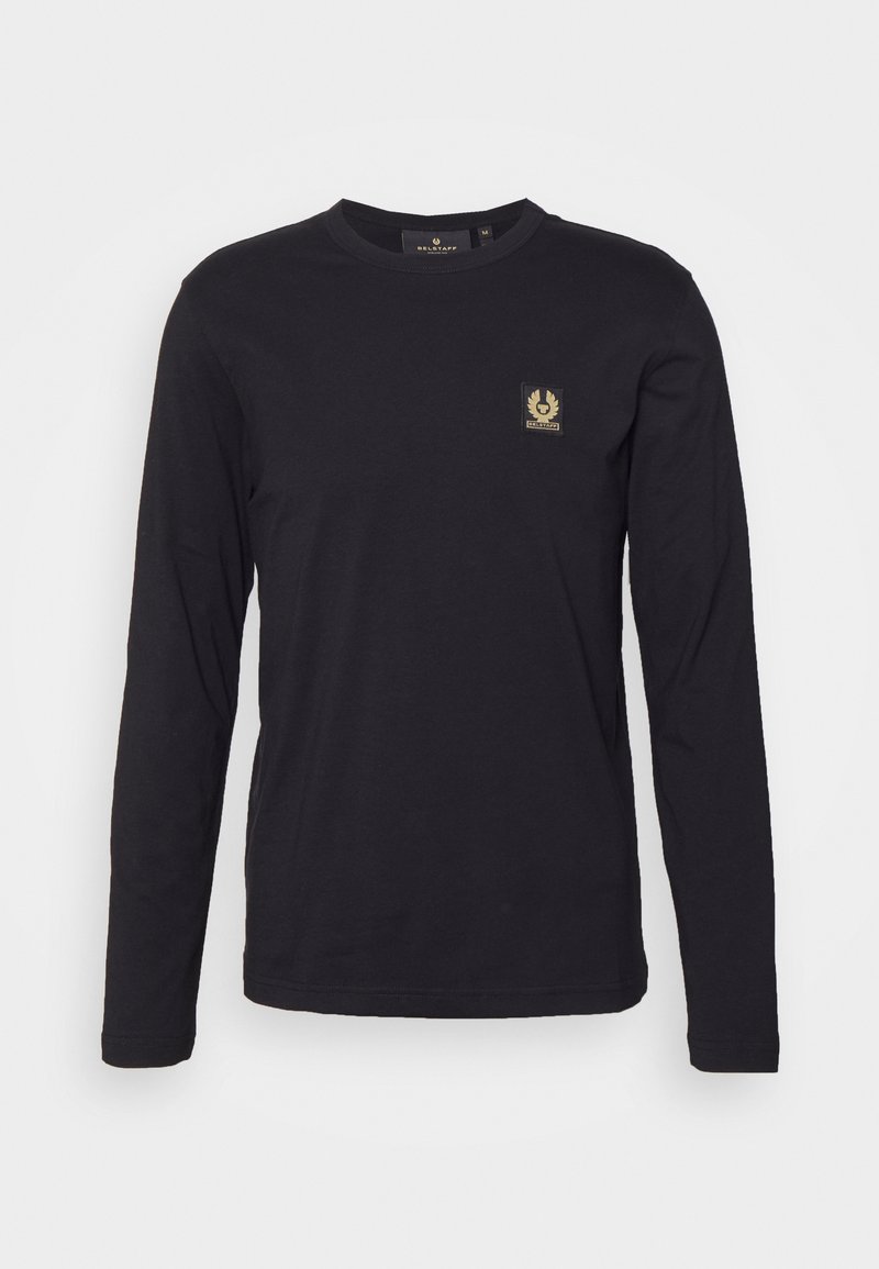 Black long-sleeve t-shirt made from cotton. Features a round neckline and a small gold logo patch on the left chest area.