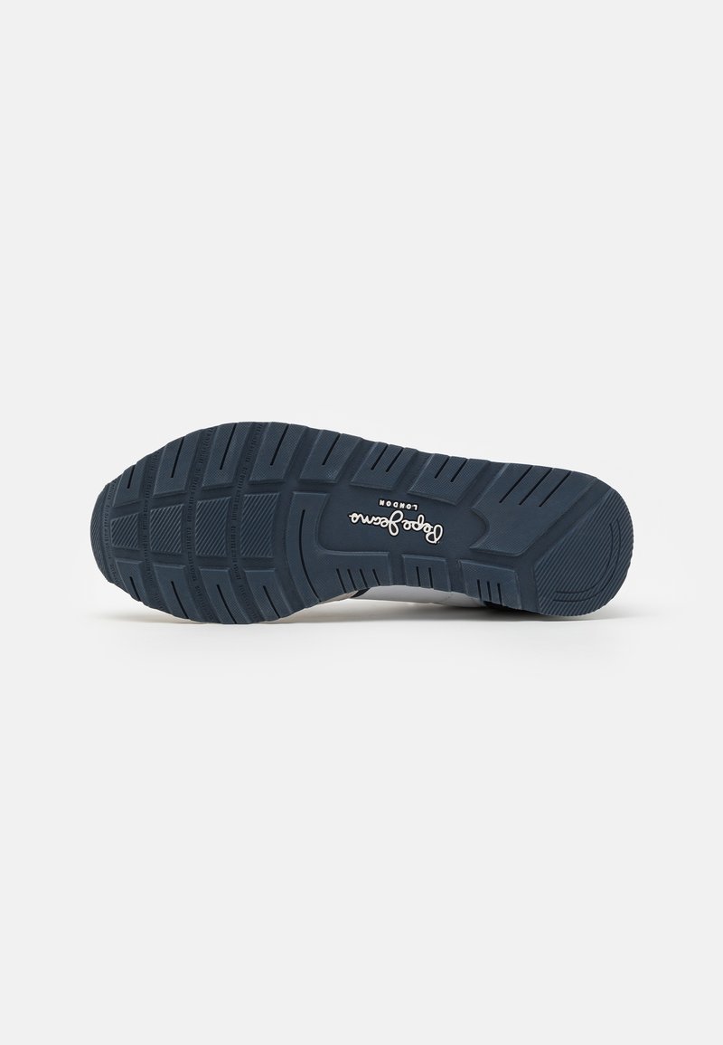 Suela de zapato de goma ligera de color azul con un patrón texturizado, que presenta surcos para tracción y un logotipo en el centro.