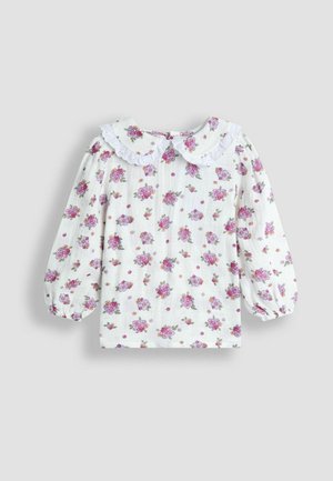 Bílá blůza s květinovým vzorem v růžové a fialové barvě. Má kulatý límec s krajkovým lemem a nafouknuté rukávy. Texturovaná látka.
