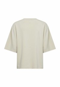 Beige, oversized t-shirt made of soft, textured fabric. Short sleeves, round neck, and minimal stitching detail. Back view only.