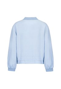 Light blue cropped jacket made of soft fabric. Features a ribbed collar and elasticized cuffs, with a smooth, slightly textured surface.