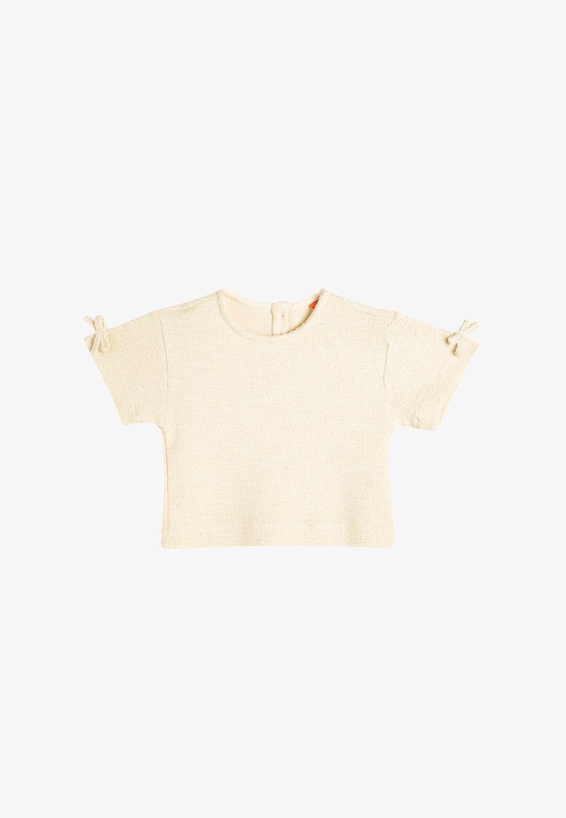 Kortærmet creme t-shirt, tekstureret strikket stof, rund halsudskæring, lukning bagpå, med små bånd på ærmerne for detaljer.