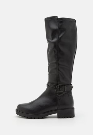 Tall black leather boot with a low block heel, round toe, and decorative strap with buckle around the ankle.