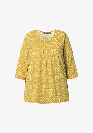 Gele tuniek met een V-hals en driekwart mouwen. Bedrukt met witte en blauwe diamanten op een gestructureerde stof. Losse pasvorm.