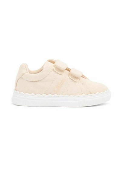 Kremowy trzewik dla malucha z dwoma paskami na rzepy, falistą białą podeszwą i subtelnym przeszyciem z boku.