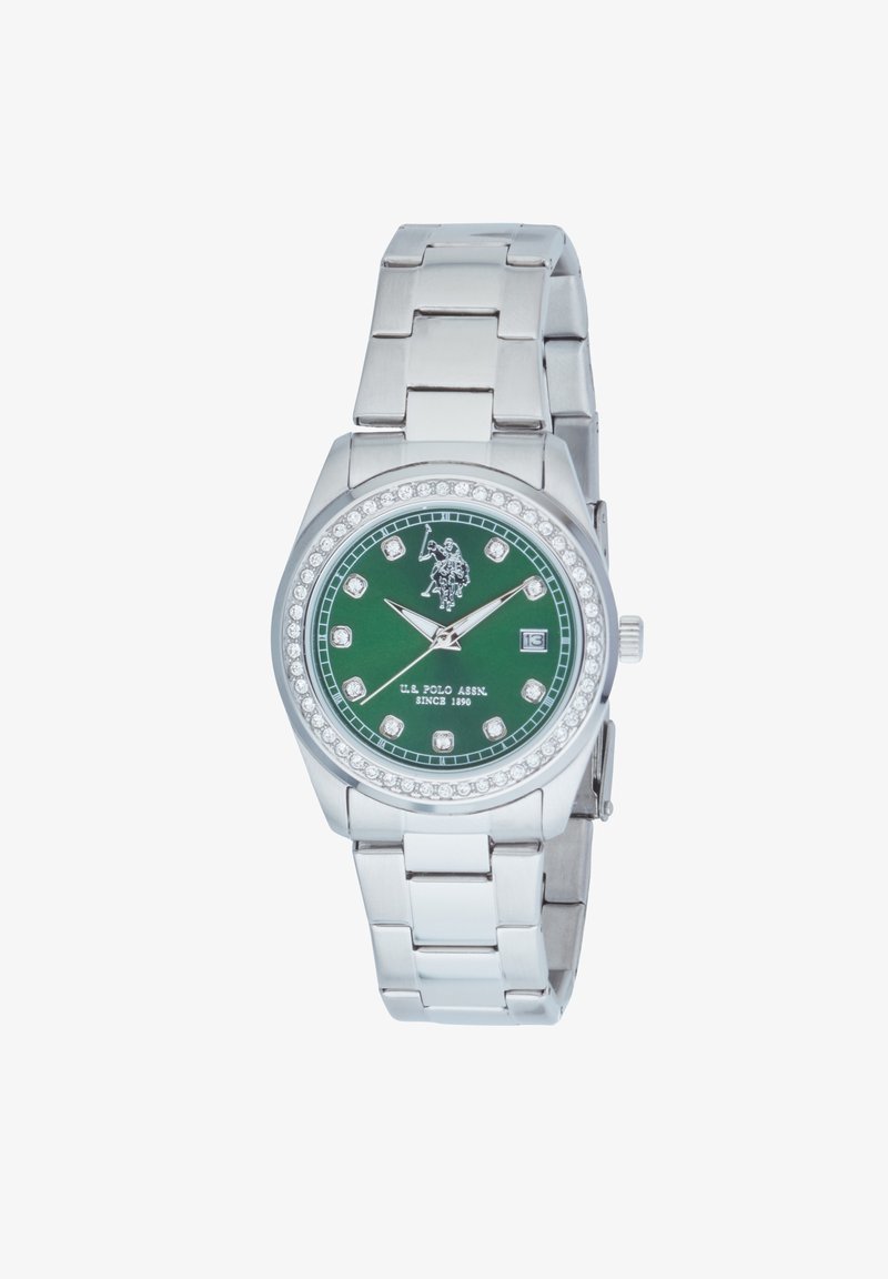 Montre en acier inoxydable argenté avec un cadran rond vert, des accents en cristal et des marqueurs d'heure argentés. Équipée d'un affichage de date à 3 heures.