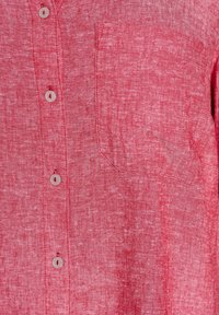 Red linen shirt featuring a buttoned front, pointed collar, and a patch pocket on the left side. Soft texture with a slight sheen.
