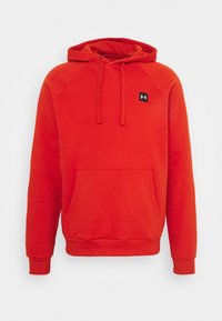 Felpa rossa con cappuccio e tasca anteriore. Realizzata in tessuto morbido, presenta maniche raglan e un piccolo logo nero sul petto.